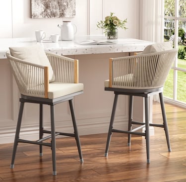 Modern outdoor swivel bar stools with rope woven backs and cream cushions at a white marble counter.
