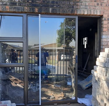 bronze aluminium door with sidelight and clear 6.38 shatterproof glass