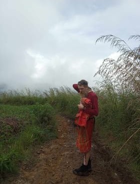 Ki Joko Moro in a field surrounded by tall grass deep in thouoght