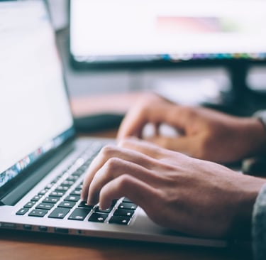 hands on a keyboard of a laptop