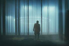 a person walking through woods illuminated by eerie lights