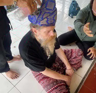 a man sitting on a white tile floor undertaking a ceremony