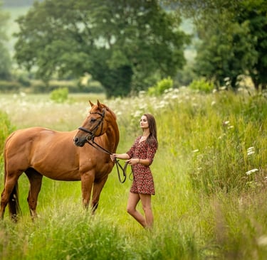 equine photograph of woman in a dress standing in a field