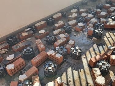 Using bricks under pedestal tiles to try and 
