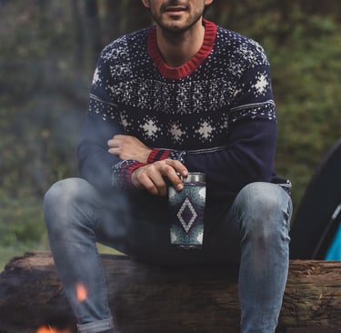 a man sitting on a log log in the woods
