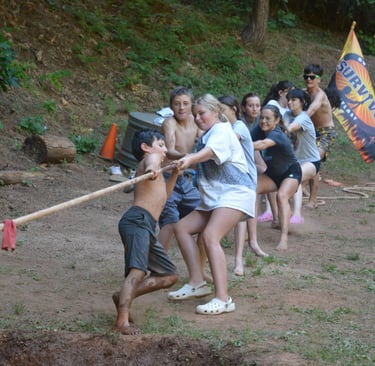 a group of campers playing tug-o-war 