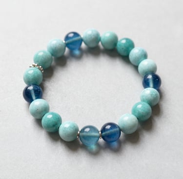 Close-up of a pair of handcrafted earrings made from recycled metals.