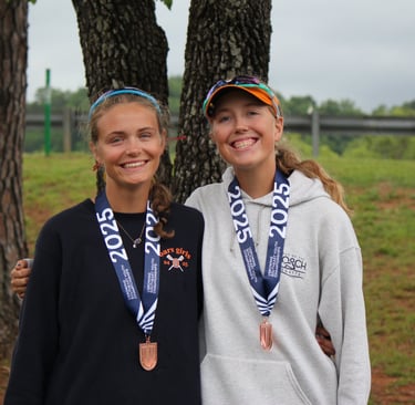 Maija and Anna Andert wearing bronze medals at 2025 Southeast Regionals