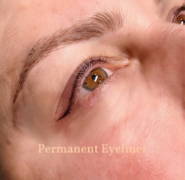 Close-up of professional permanent eyeliner tattoo and lash enhancement on a woman's eyelid.