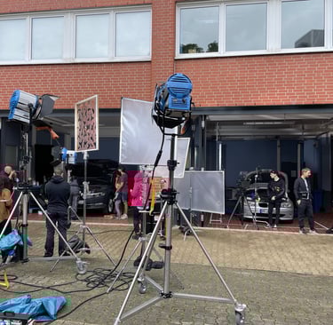 a group of people standing around a camera