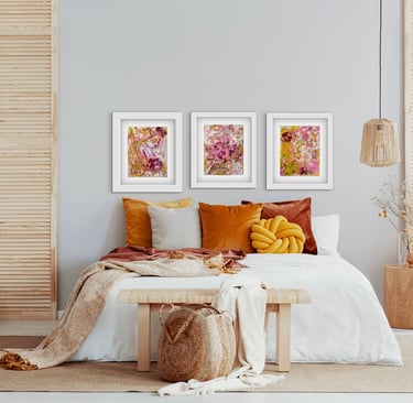 a bedroom with orange pillows and artwork used as a headboard