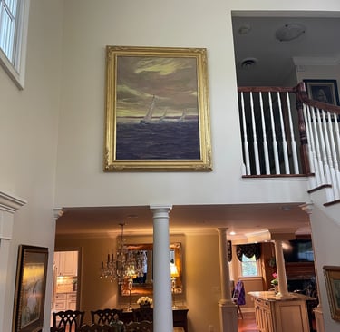 large oil painting hanging on a wall in client's home