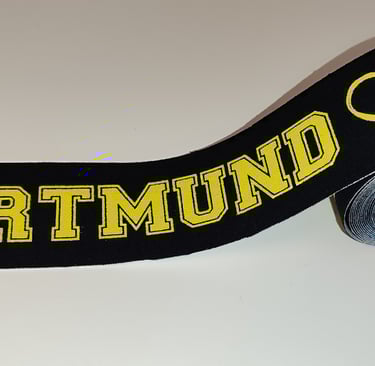 a black and yellow ribbon with a heart on it