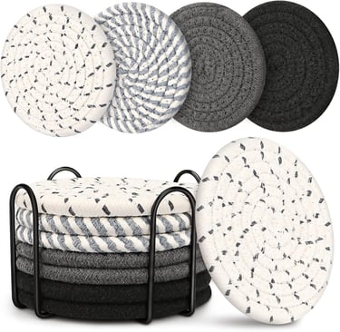 a stack of four round coasters with a black and white pattern