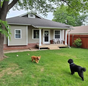 two dogs are standing in the grass in front of a house