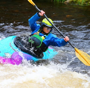 women in pyranha ozone in paddling down the upper Tryweryn 