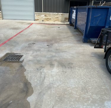 Parking lot after dirt and rust stains from dumpster have been removed