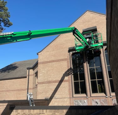 Using lift to clean high windows a ladder will not reach