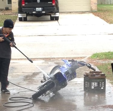 Santiago, Pressure Washing his dirt bike at a young age