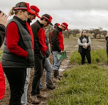 a group of people standing in a field