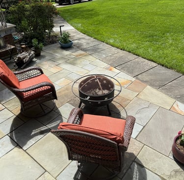 Spacious front patio with colorful natural stone in a random pattern