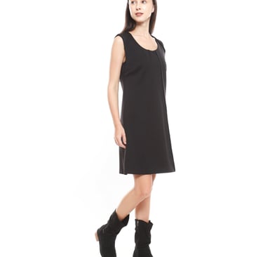 A woman wearing little back dress in black ankle boots