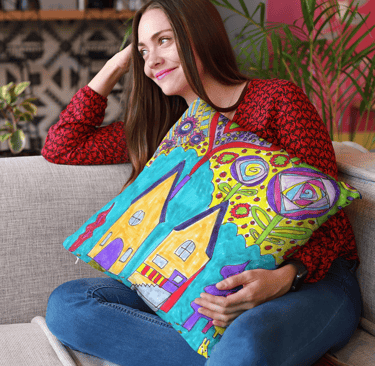 Woman sitting holding a Throw Pillow