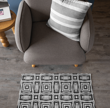 Area rug on floor in front of chair.