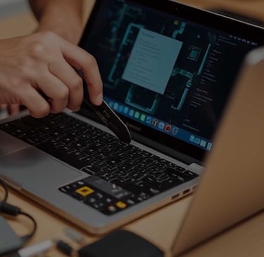 a person is using a laptop computer and a pen