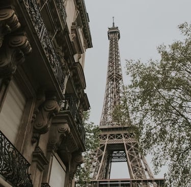 a tall tower with a clock tower in the background
