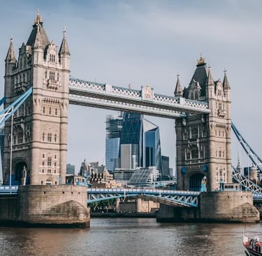 a bridge spanning the river with a boat in the background