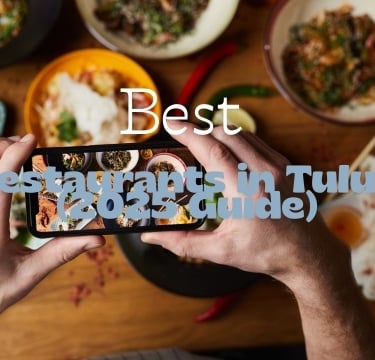 a person taking a photo of a table with food and a phone