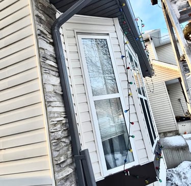 Everdrains team removing hail damaged gutter system in Calgary.