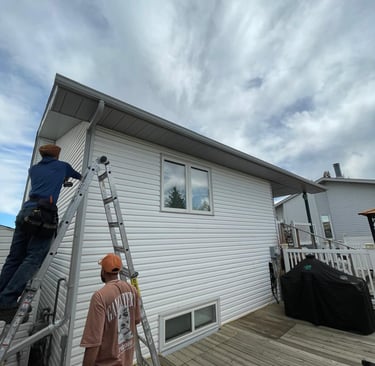 Technician repairing damaged residential gutter.