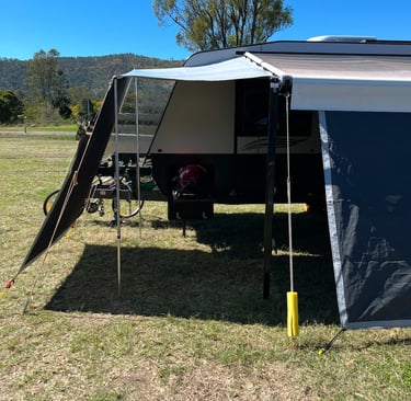 Front or rear caravan awning extension with privacy screen drop for extra shade and shelter