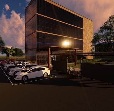 Modern glass office building architecture with a parking lot and solar canopy at sunset.
