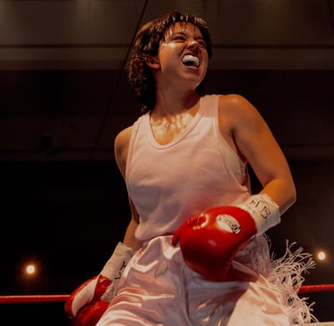 Christy Martin in a white dress and red boxing gloves