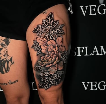 Large floral thigh tattoo with bold blackwork shading