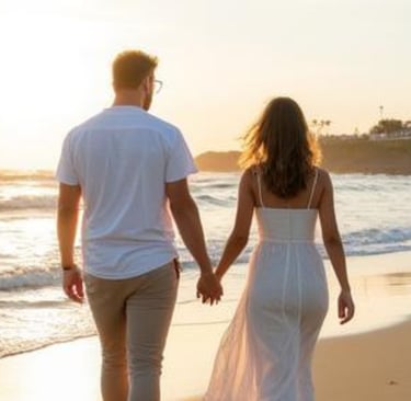 Couple holding hands while walking along the beach at sunset in Santa Barbara, California