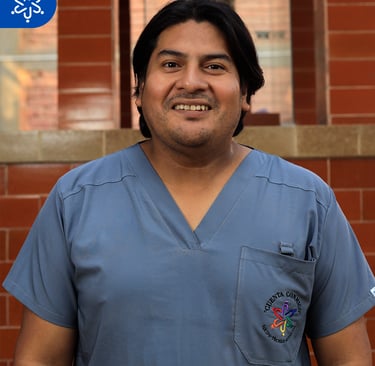 a man in scrubies and scrubies standing in front of a brick wall