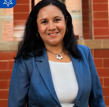 a woman in a blue jacket and white top