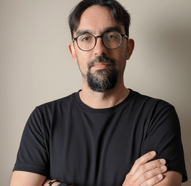 a man with glasses and a watch on his wrist