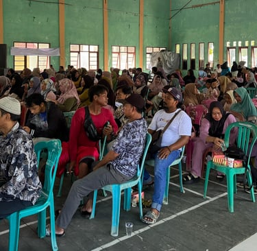 a large group of people sitting in chairs in a room