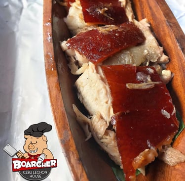 lechon slices on a wood plate