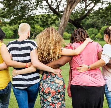 Group of women with their arms around each other