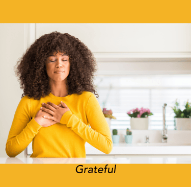 Woman expressing gratitude with her hands on her heart