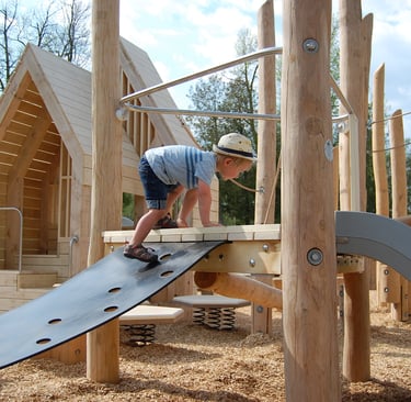 Earthscapes Play Structure with boy climbing on it