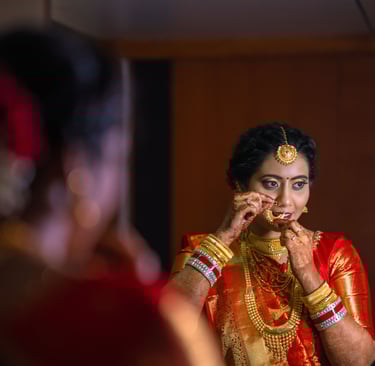 a woman in a red sari and gold jewelry , Wedding photography