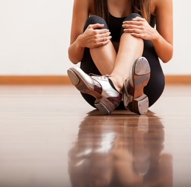 a woman sitting on the floor with her legs crossed