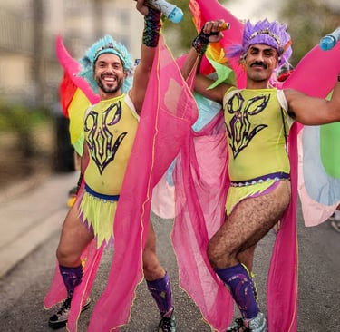two men in colorful costumes are dancing in the street